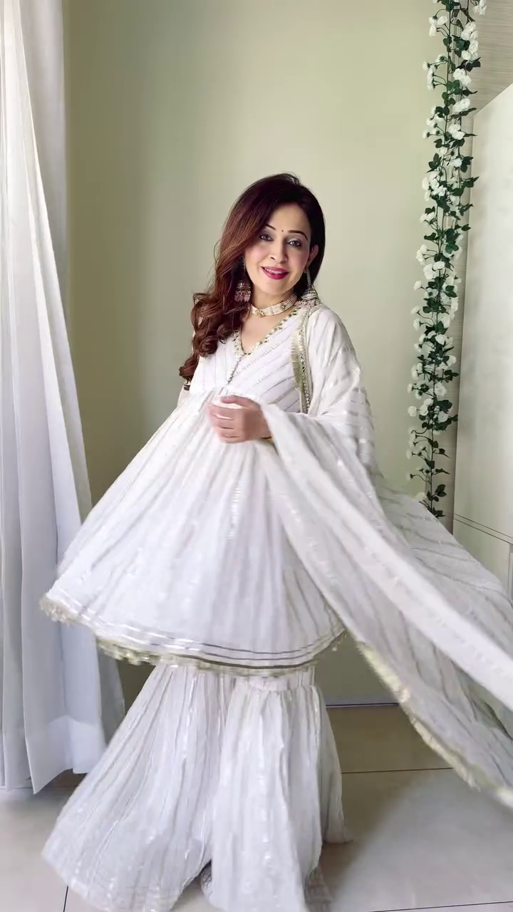 The outfit looks stunning! The white color with intricate detailing, paired with beautiful jewelry, gives a traditional and elegant vibe