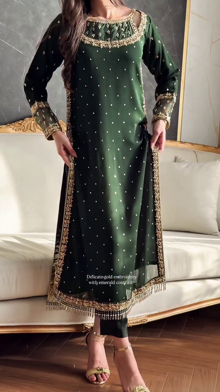 A stunning emerald green ethnic ensemble featuring delicate gold embroidery with an emerald contrast, paired with a matching dupatta and elegant gold accessories, perfect for a festive or formal occasion.