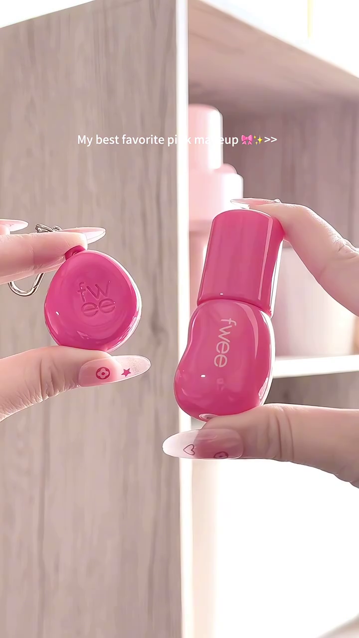 A collection of my favorite pink makeup shades, featuring a vibrant pink lip product in a cute bottle, swatched beautifully on the hand for a soft yet bold pink finish.