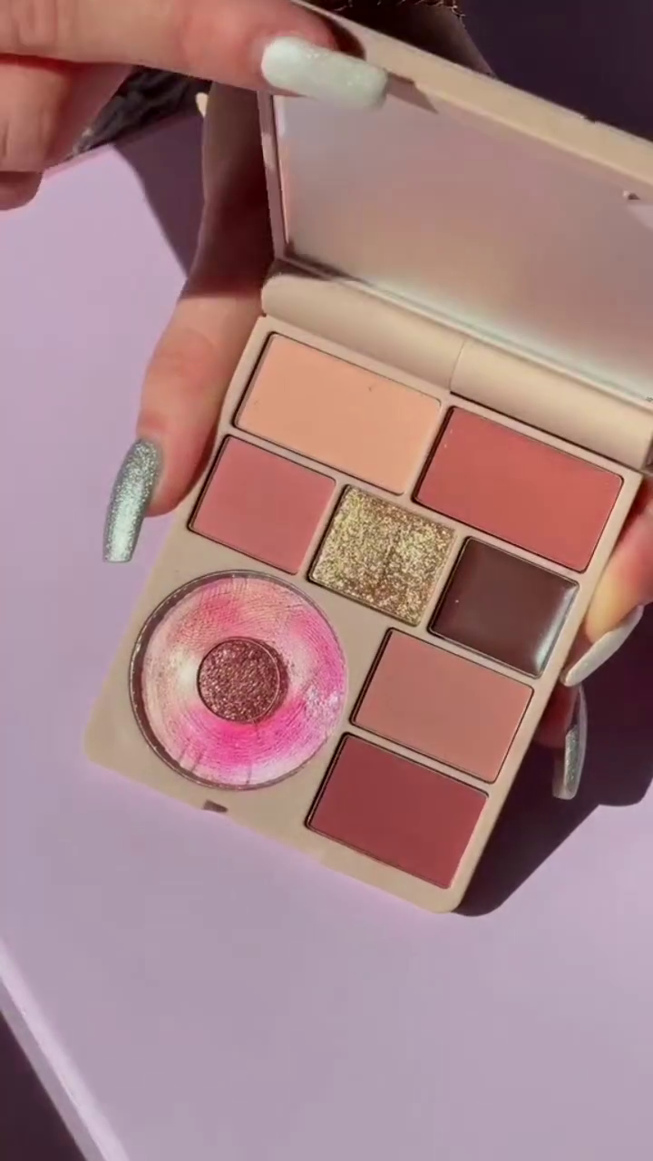A versatile eyeshadow collection featuring vibrant, bold shades like yellow, orange, and blue with sparkling glitters