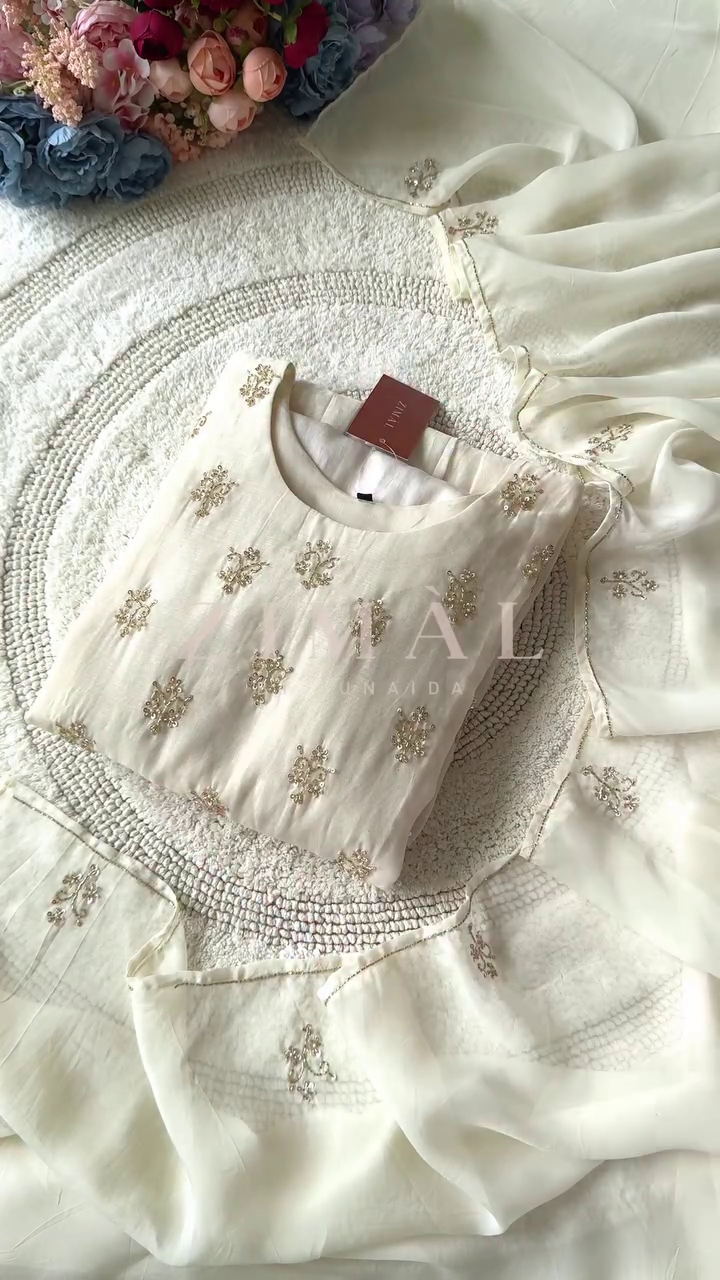Elegant Cream-Colored Anarkali Dress with Delicate Embroidery and Pleated Detailing, Paired with a Soft Sheer Dupatta for a Graceful Look