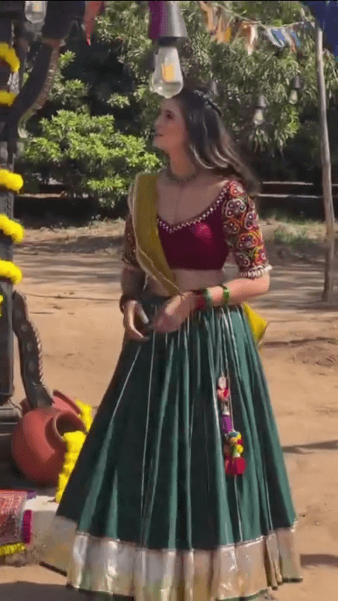 Vibrant Traditional Mirror Work Lehenga Set Featuring Deep Maroon Embroidered Choli, Bottle Green Flared Skirt with Tassels, and Contrasting Yellow Dupatta – Ideal for Navratri & Cultural Festivities