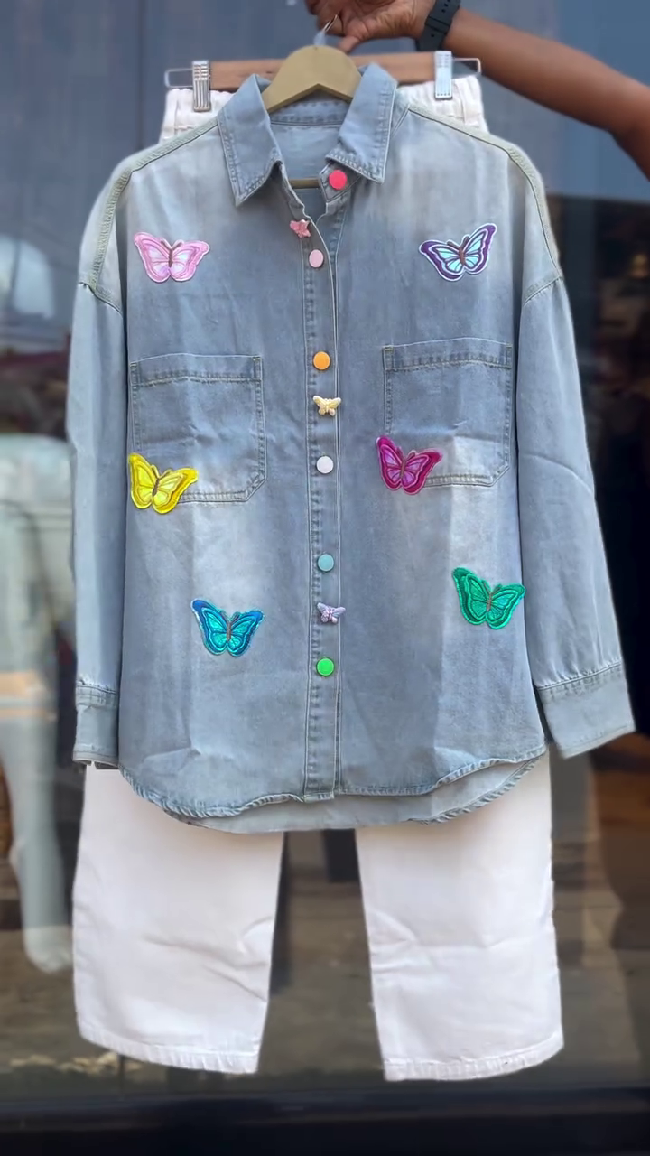 Trendy Two-Piece Set Featuring a Light Wash Denim Shirt Embellished with Colorful Butterfly Embroidery and Contrasting Multicolor Buttons, Paired with Classic High-Waist Straight-Cut White Jeans – Perfect for a Vibrant and Playful Casual Look