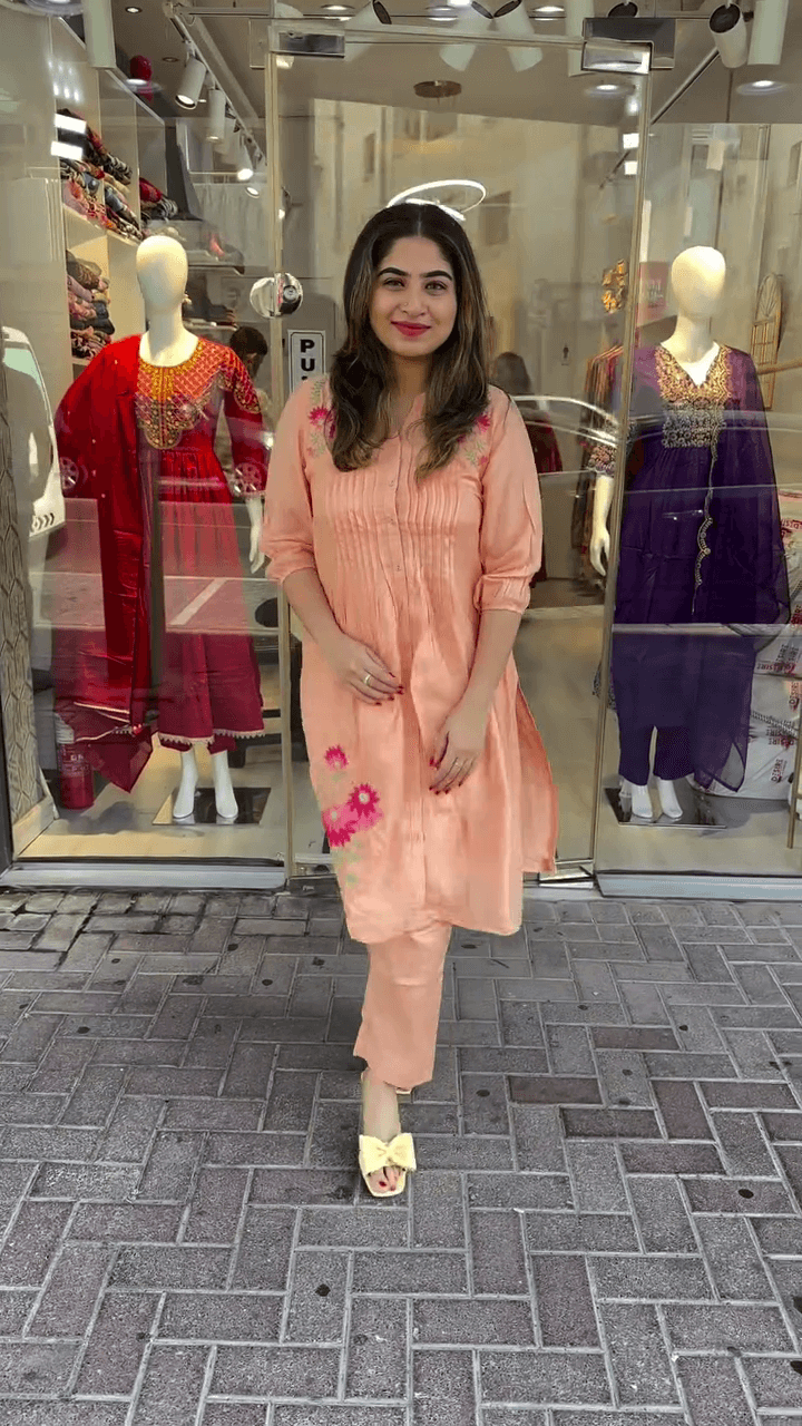 Charming Peach Embroidered Kurti with Floral Detailing and Pleated Design for a Fresh, Elegant Look