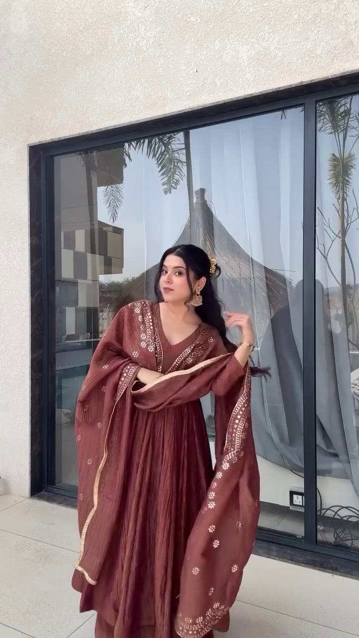This outfit looks so graceful! The earthy brown color combined with the delicate embroidery and the flowy silhouette gives it a warm