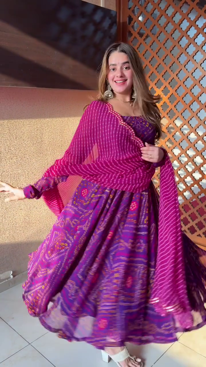 Such a vibrant and cheerful outfit! The purple hues with the intricate prints look so lively, and the flow of the dress is perfect for twirling