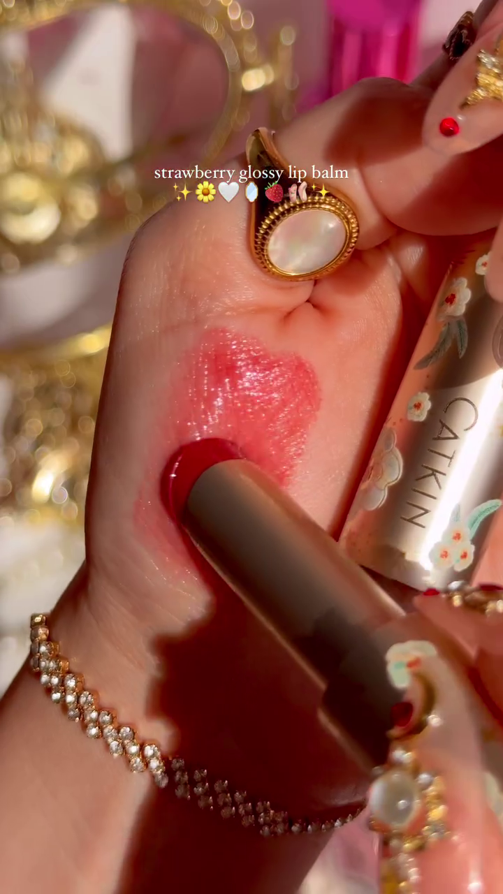 Strawberry Glossy Lip Balm with a Beautiful Floral Design, Offering a Hydrating and Glossy Finish for Soft, Smooth Lips with a Touch of Sweet Strawberry Scent