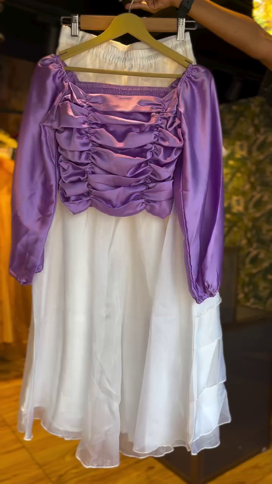Two-Piece Set Featuring a Ruched Satin Lavender Long Sleeve Crop Top with Off-Shoulder Detailing Paired with a Flowing Layered White Organza Midi Skirt for a Dreamy Ethereal Look