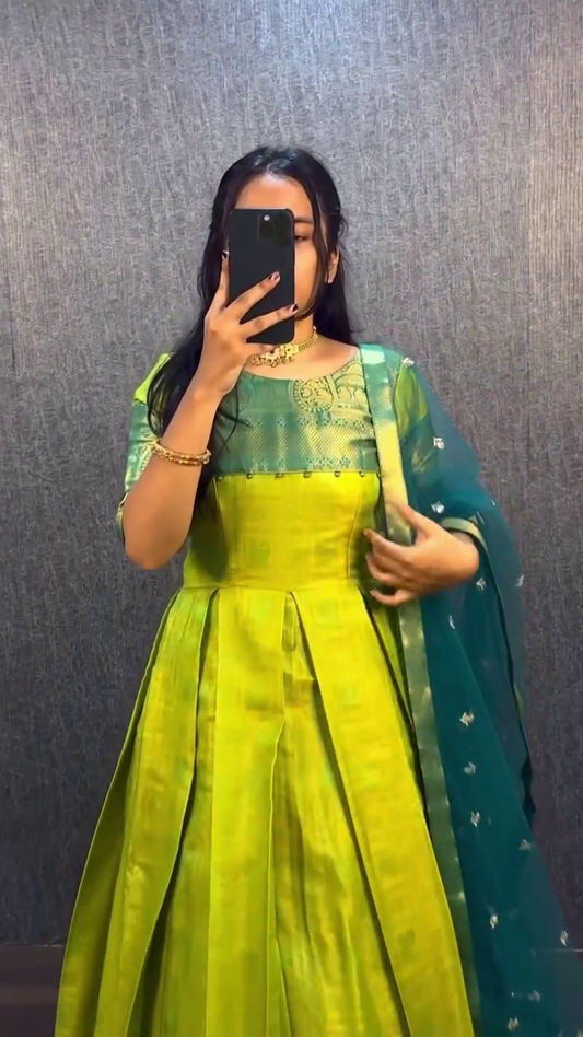 Traditional Banarasi Silk Gown Set in Vibrant Lime Green with Zari Woven Detailing and Net Dupatta Paired with Festive Mustard Yellow and Maroon Banarasi Silk Gown Featuring Rich Patterns and Maroon Net Dupatta – Perfect for Weddings and Celebrations